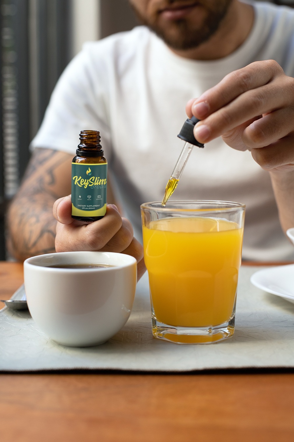 Man adding drops to morning drink