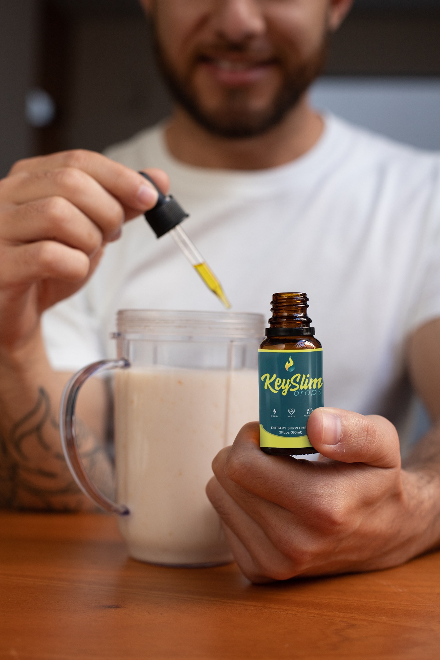 Man adding drops to smoothie